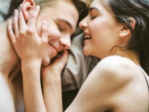 A joyful and intimate moment of a young couple embracing and smiling together.