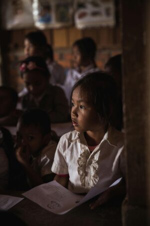 Focused children in a dimly lit classroom attentively listening and studying. शिक्षा और छात्र भविष्यफल 2026: क्या इस साल मिलेगी आपको मनचाही सफलता?