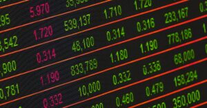 Close-up of a digital stock market data display showing colorful financial numbers and trends.