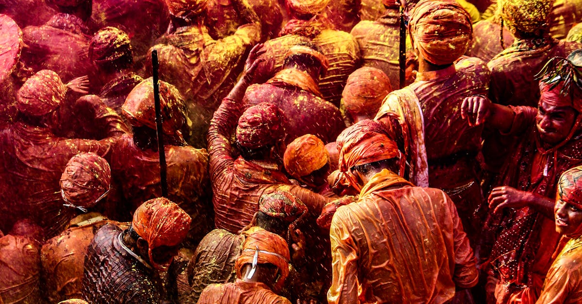 Colorful crowd celebrating Holi with vibrant powders in India.